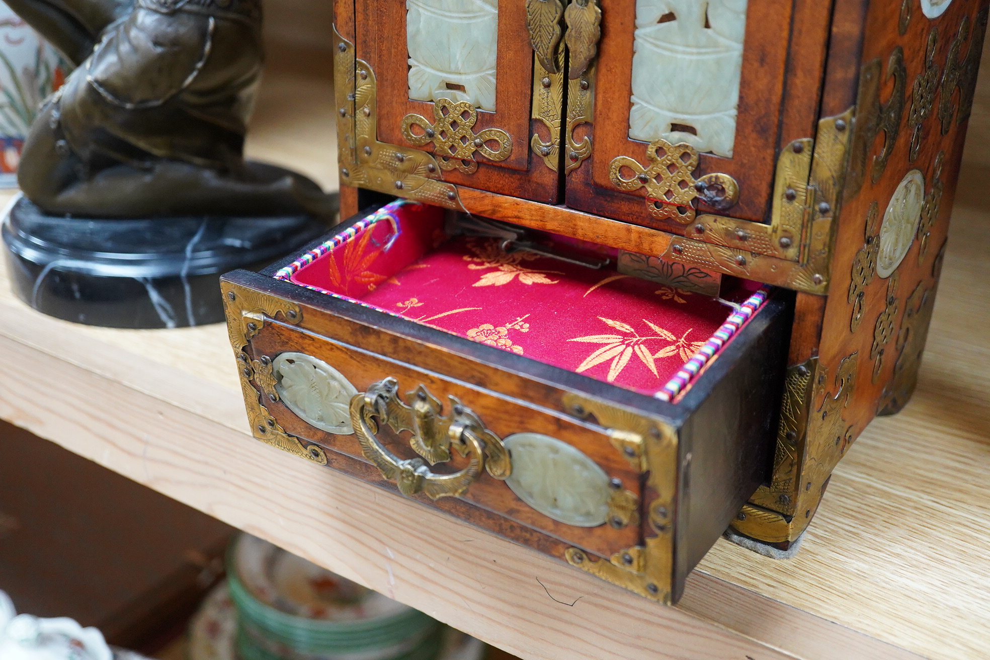 A Chinese walnut jewellery box with carved bowenite jade panels, 24.5cm high